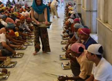 Serving at Langar in Gurudwara, where a free meal is served to all the visitors, without distinction of religion, caste, gender, economic status or ethnicity